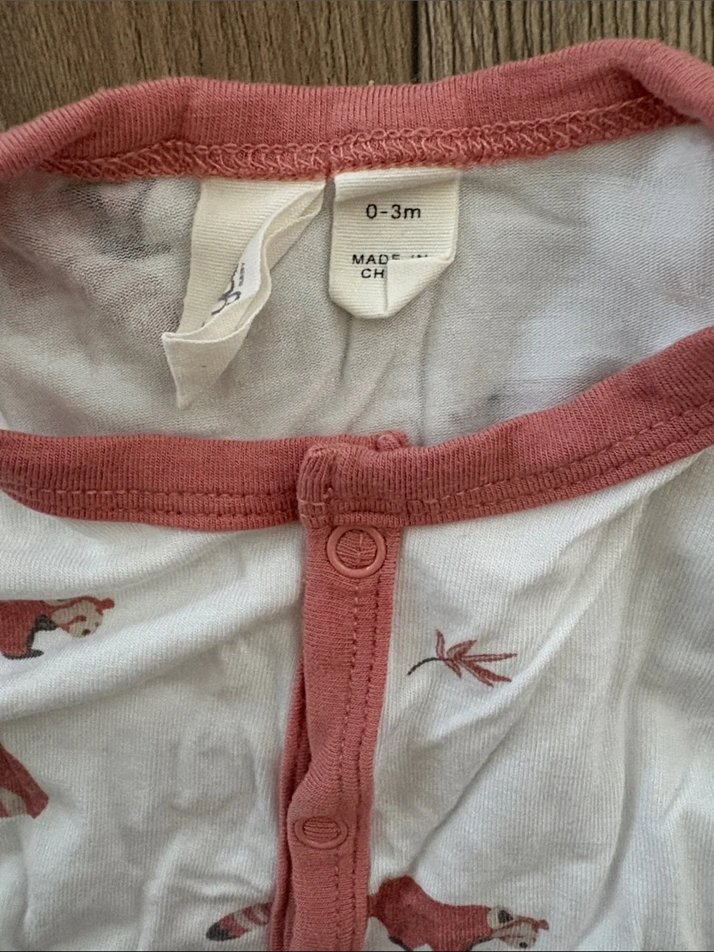 Kyte BABY White Footed One-Piece with Coral Trim and Animal Print